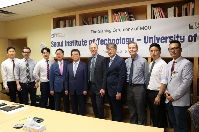 10 men in suits standing in a line