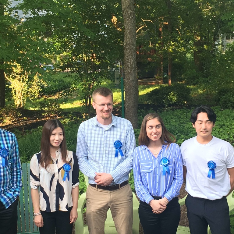 5 people outside wearing a blue ribbon attached to their shirts